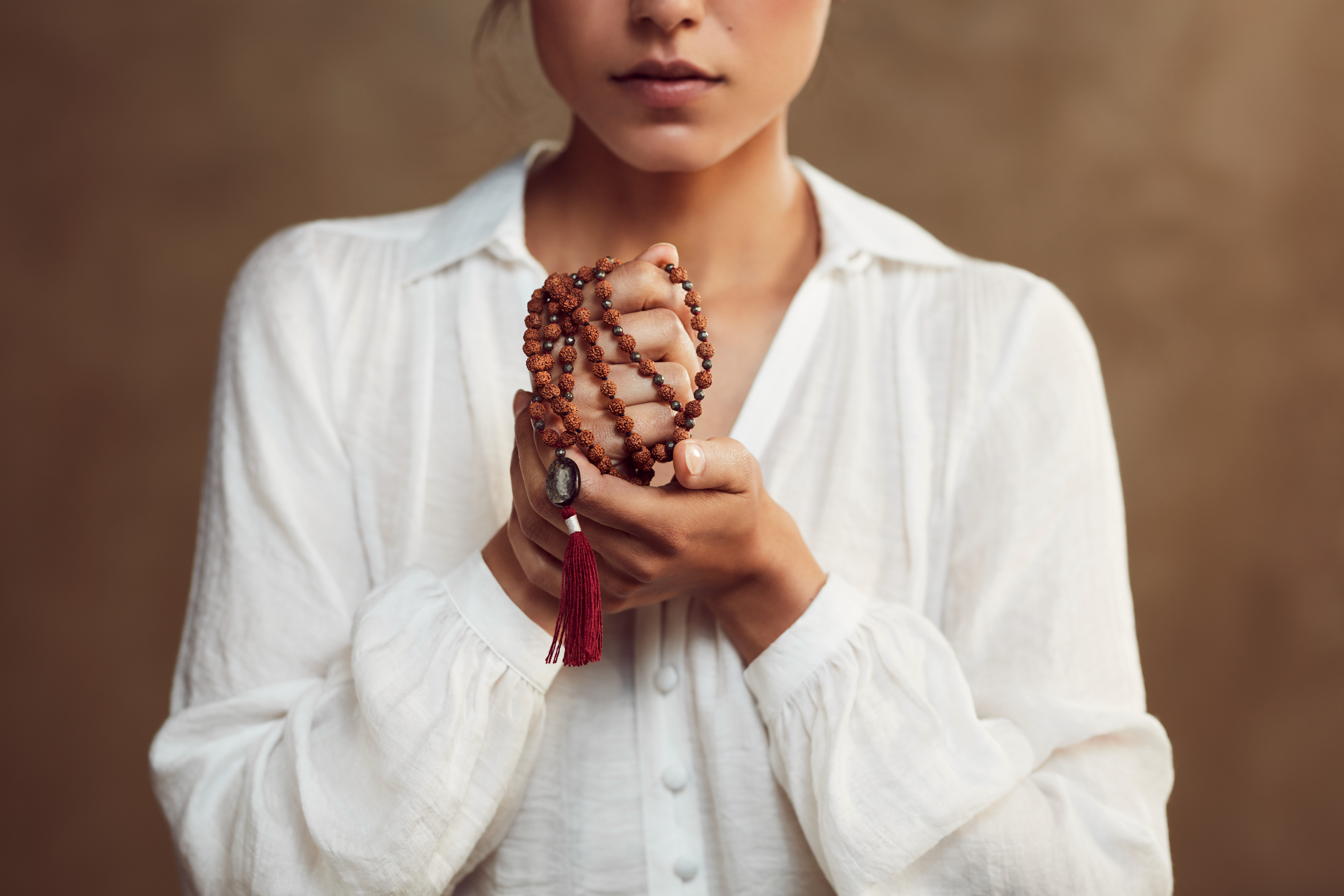  how to cultivate compassion, woman holding prayer beads